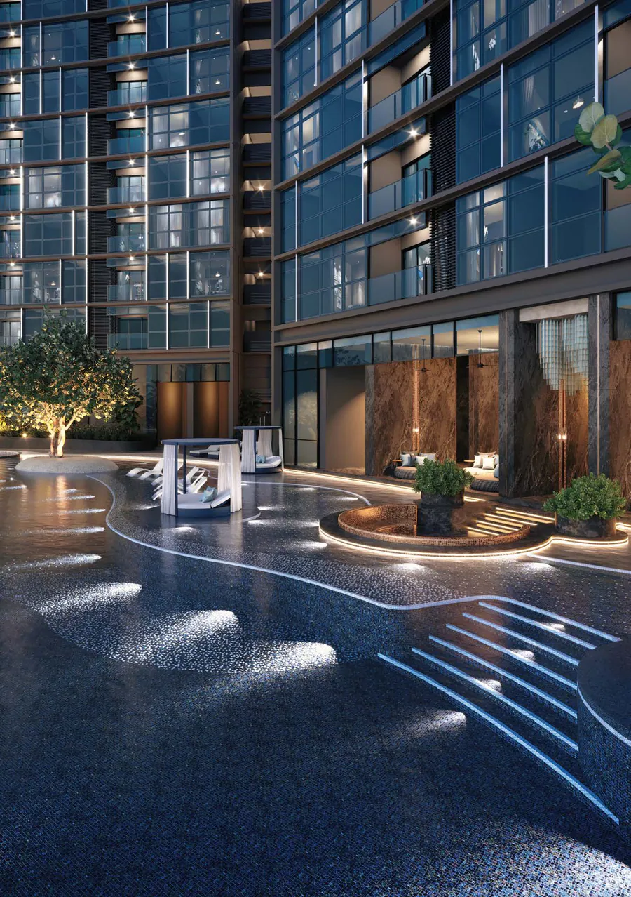 The infinity pool at night: lights on the water run along the steps and channels, with the towers’ glass façades behind (CGI)